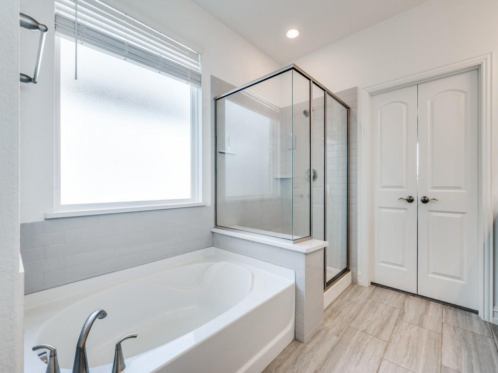4408 Minnow Cove Oak Point, TX 75068 - Photo 12 of 31 a bathroom with a bathtub and a shower