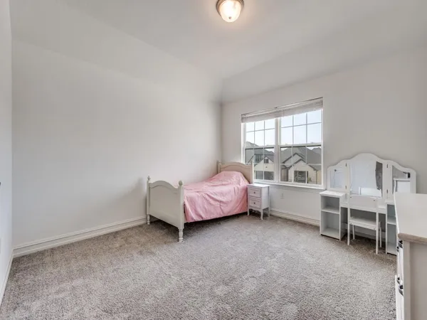 a spacious bedroom with a bed and a window