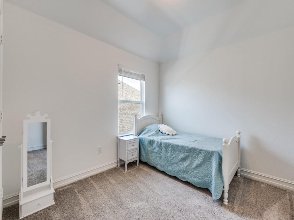 4408 Minnow Cove Oak Point, TX 75068 - Photo 18 of 31 a bedroom with a bed and a window