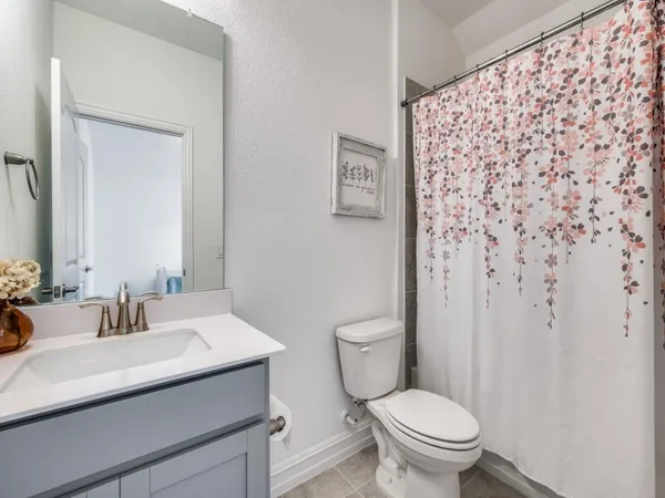 a bathroom with a sink toilet and a mirror