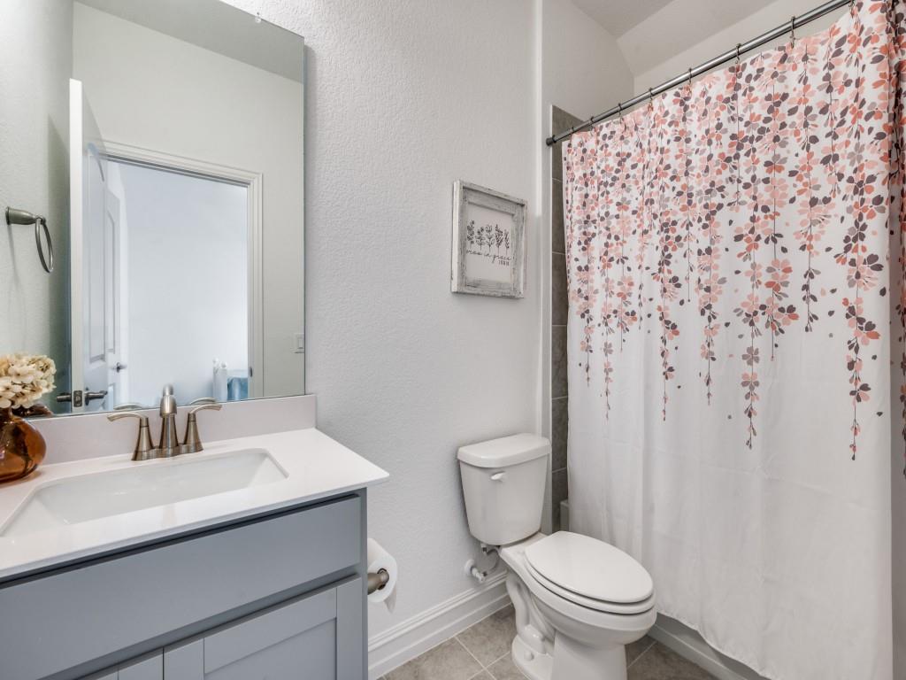 4408 Minnow Cove Oak Point, TX 75068 - Photo 19 of 31 a bathroom with a sink toilet and a mirror