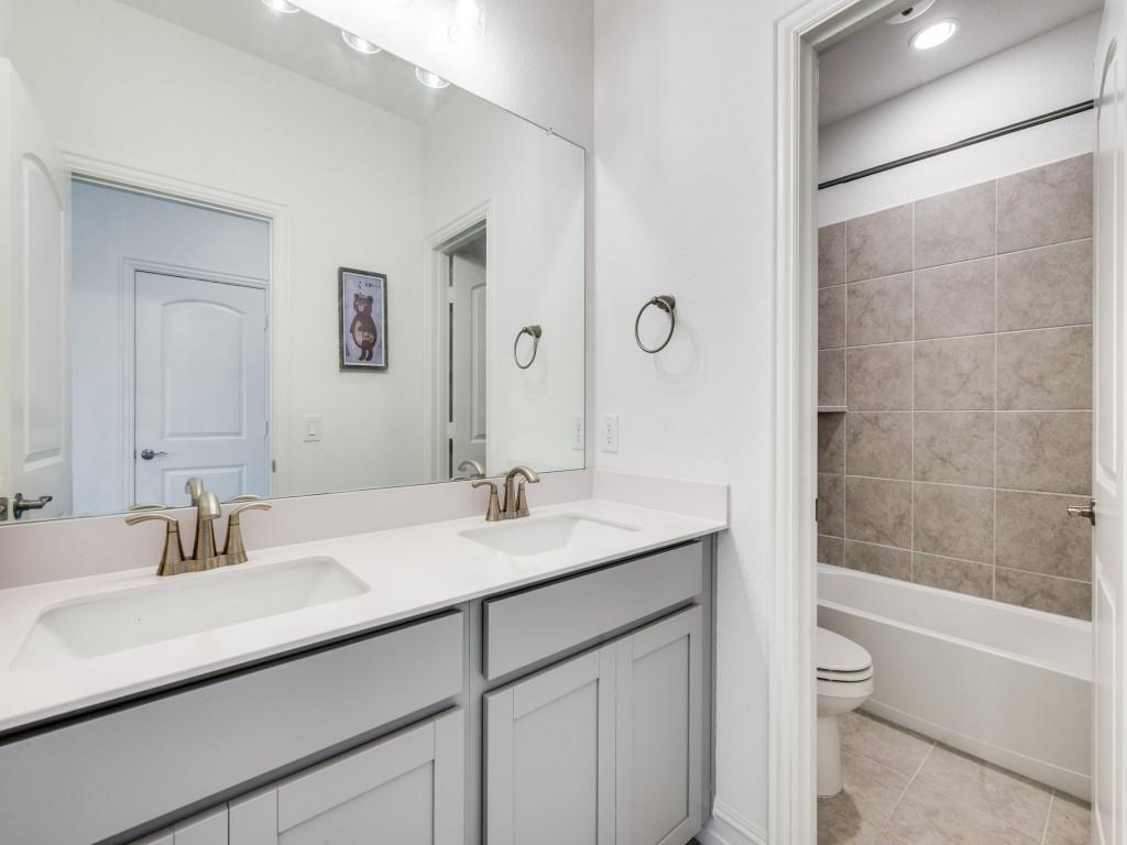 4408 Minnow Cove Oak Point, TX 75068 - Photo 21 of 31 a bathroom with a sink and a mirror