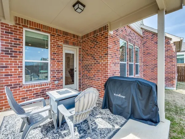 a view of a patio with a table and chairs