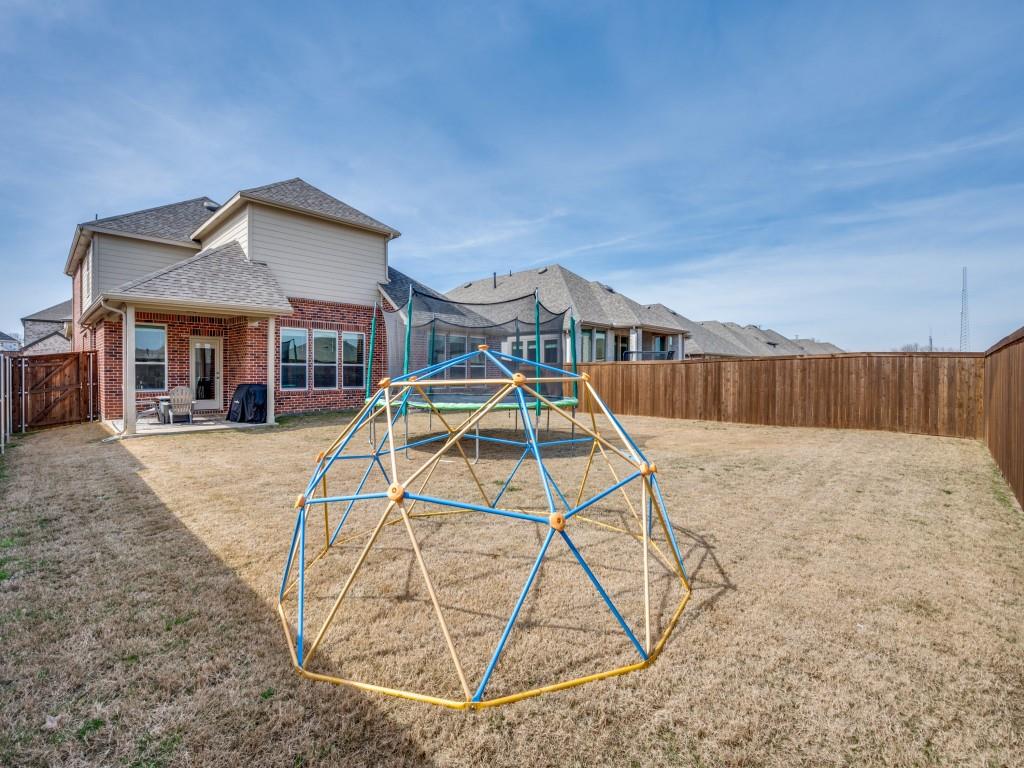 4408 Minnow Cove Oak Point, TX 75068 - Photo 23 of 31 a view of a house with a yard and wooden fence