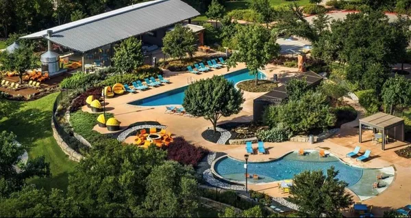 an aerial view of a house with a yard and lake view