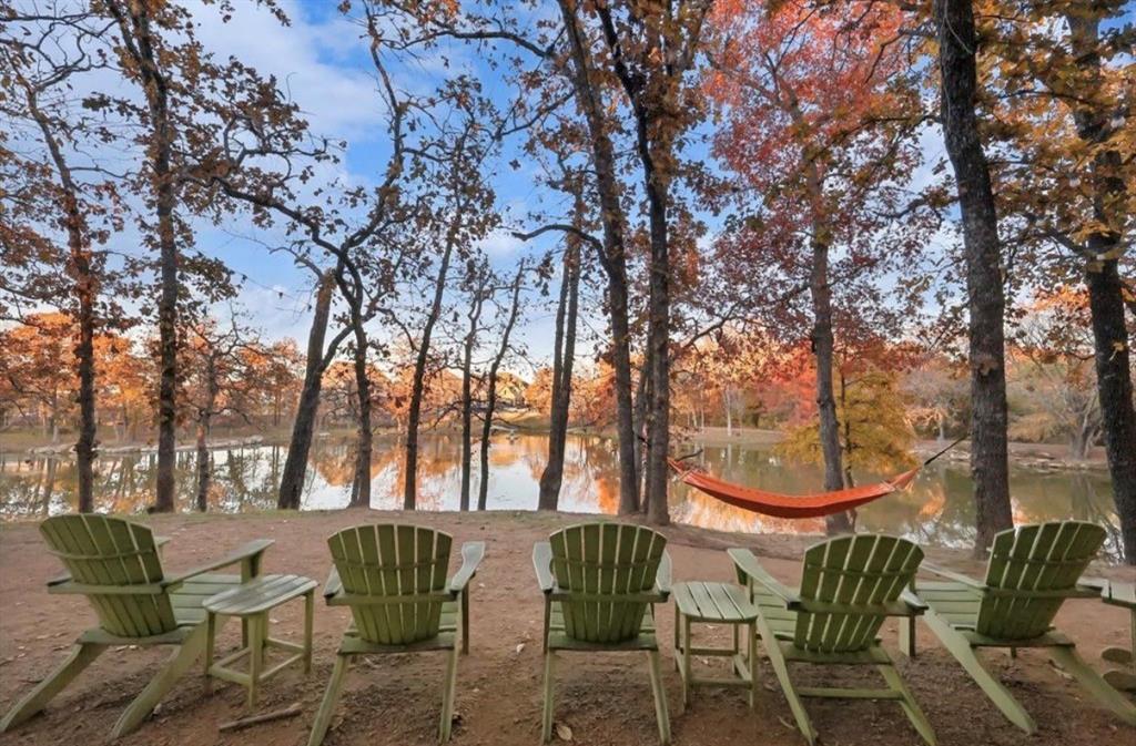 4408 Minnow Cove Oak Point, TX 75068 - Photo 29 of 31 a backyard of a house with table and chairs