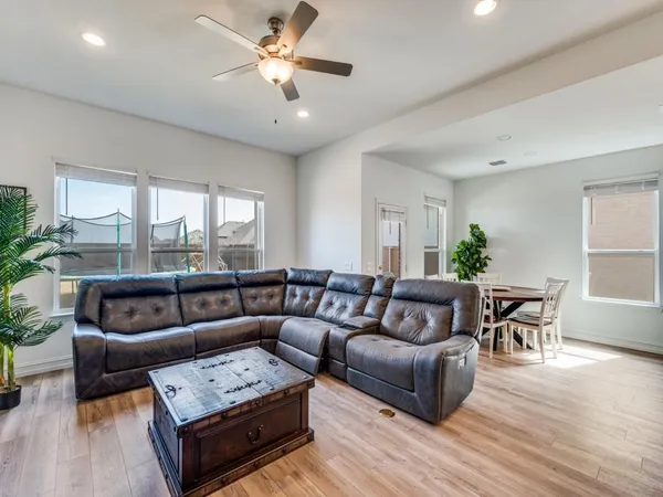 a living room with furniture and a wooden floor