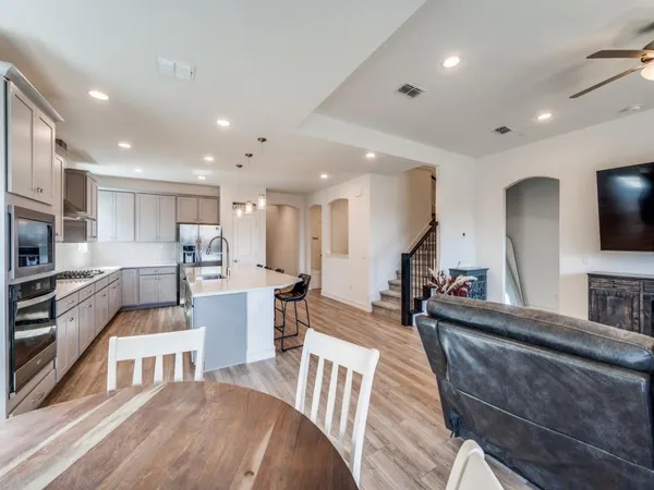 a large kitchen with stainless steel appliances lots of counter space and a sink