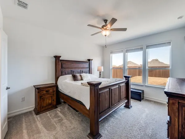 a bed room with a bed and a large window