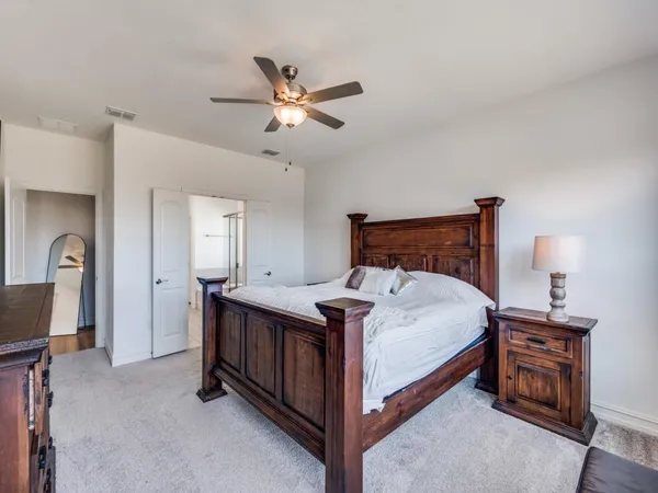 a bedroom with a bed and a chandelier