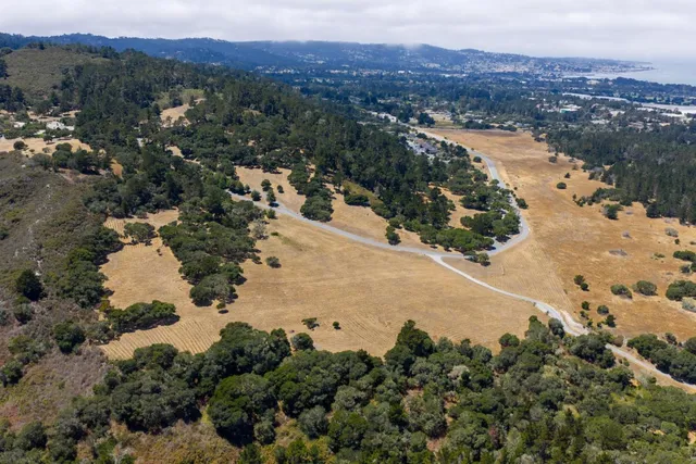 an aerial view of residential house with beach and mountain view
