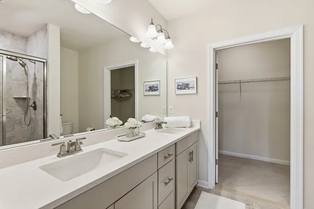 a bathroom with a sink double vanity and a mirror