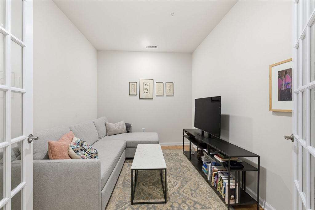 401 Emery Lane, Unit 304 Sudbury, MA 01776 - Photo 17 of 25 a living room with furniture and a flat screen tv