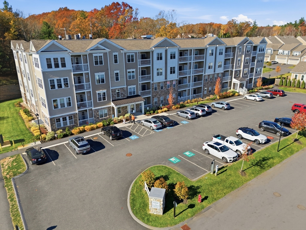 401 Emery Lane, Unit 304 Sudbury, MA 01776 - Photo 2 of 25 a view of a white house with a yard patio and sitting area