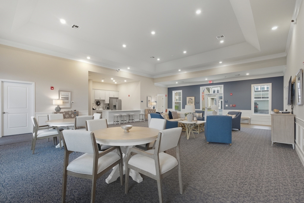 401 Emery Lane, Unit 304 Sudbury, MA 01776 - Photo 22 of 25 a dining room with furniture and wooden floor