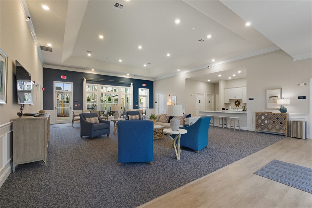 401 Emery Lane, Unit 304 Sudbury, MA 01776 - Photo 23 of 25 a living room with furniture and a large window