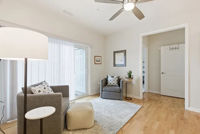 a living room with furniture and a wooden floor