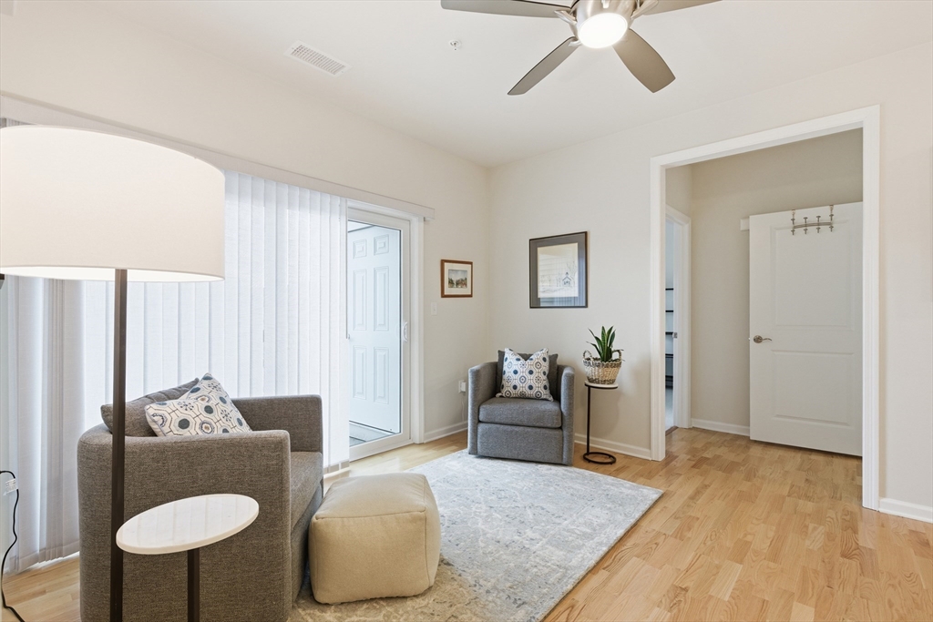 401 Emery Lane, Unit 304 Sudbury, MA 01776 - Photo 7 of 25 a living room with furniture and a wooden floor