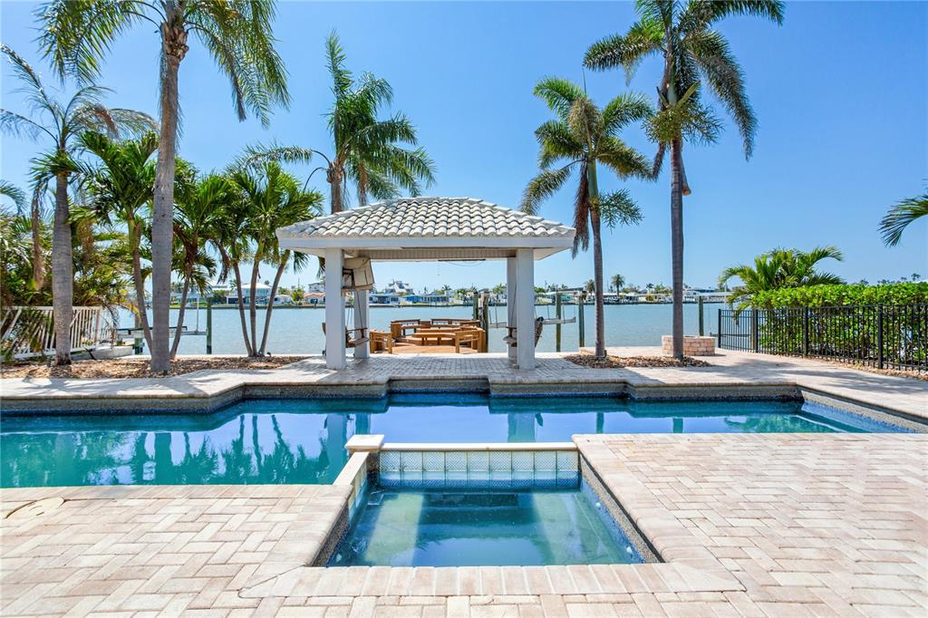 16353 Redington Drive Redington Beach, FL 33708 - Photo 1 of 1 a view of a swimming pool with a patio