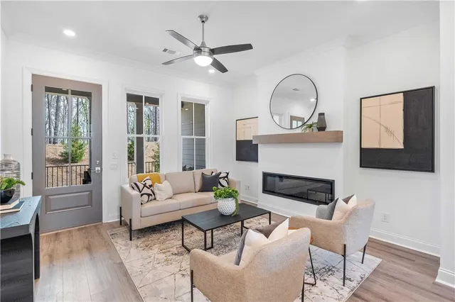 a living room with furniture a fireplace and a flat screen tv