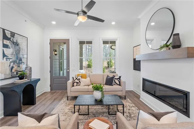 a living room with furniture a fireplace and a potted plant