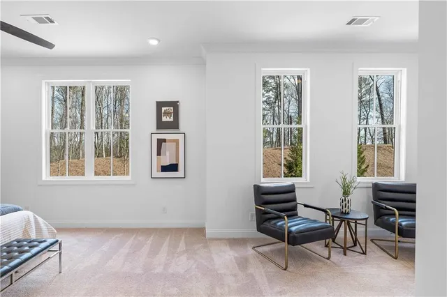 a living room with furniture and two window