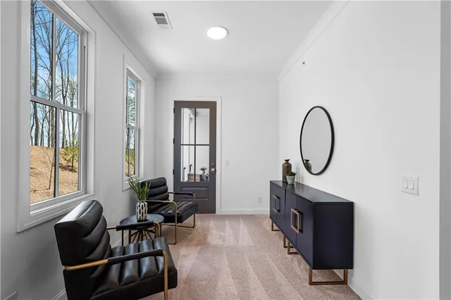 a living room with furniture a window and a chandelier