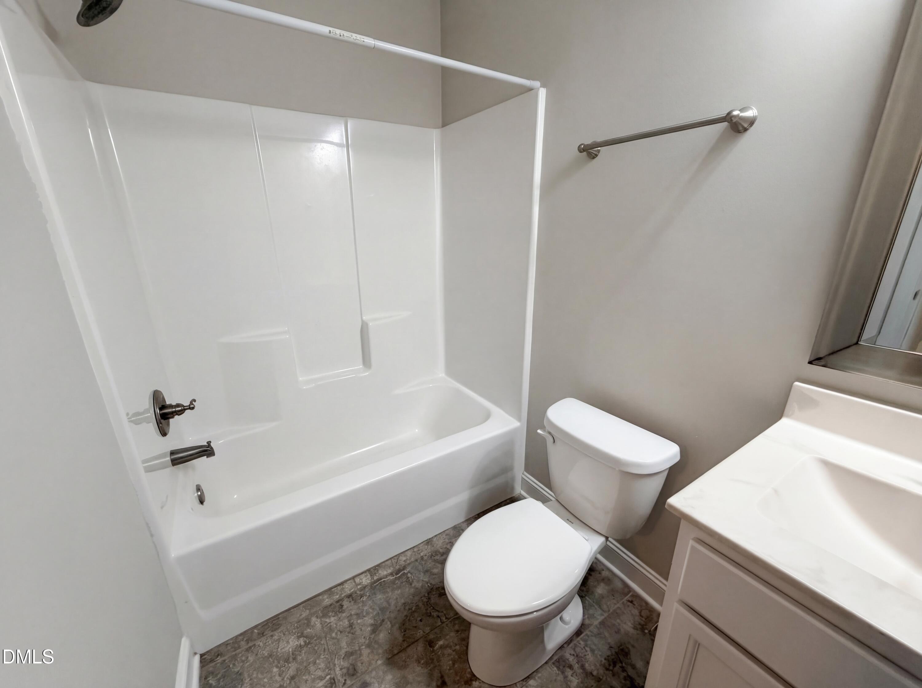 987 Red Stone Court Rougemont, NC 27572 - Photo 12 of 14 a white toilet sitting next to a bathroom sink and tub