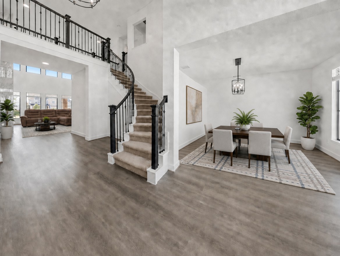 1440 Riva Ridge Drive Leander, TX 78641 - Photo 4 of 37 Elegant hardwood flooring flows through this home's airy living spaces, complementing the grand staircase and formal dining room.