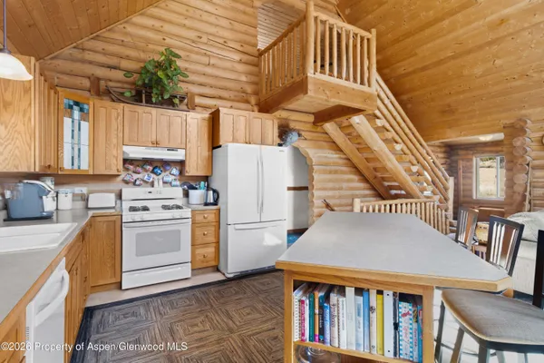 a kitchen view with table chairs and a stove