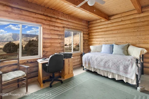 a bedroom with a bed chair and window