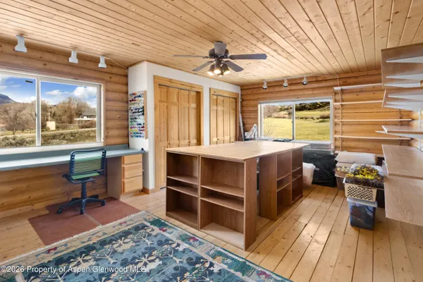a bedroom with a bed and a table in it