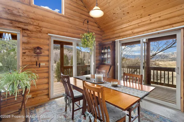 a view of a dining room with furniture window and outside view