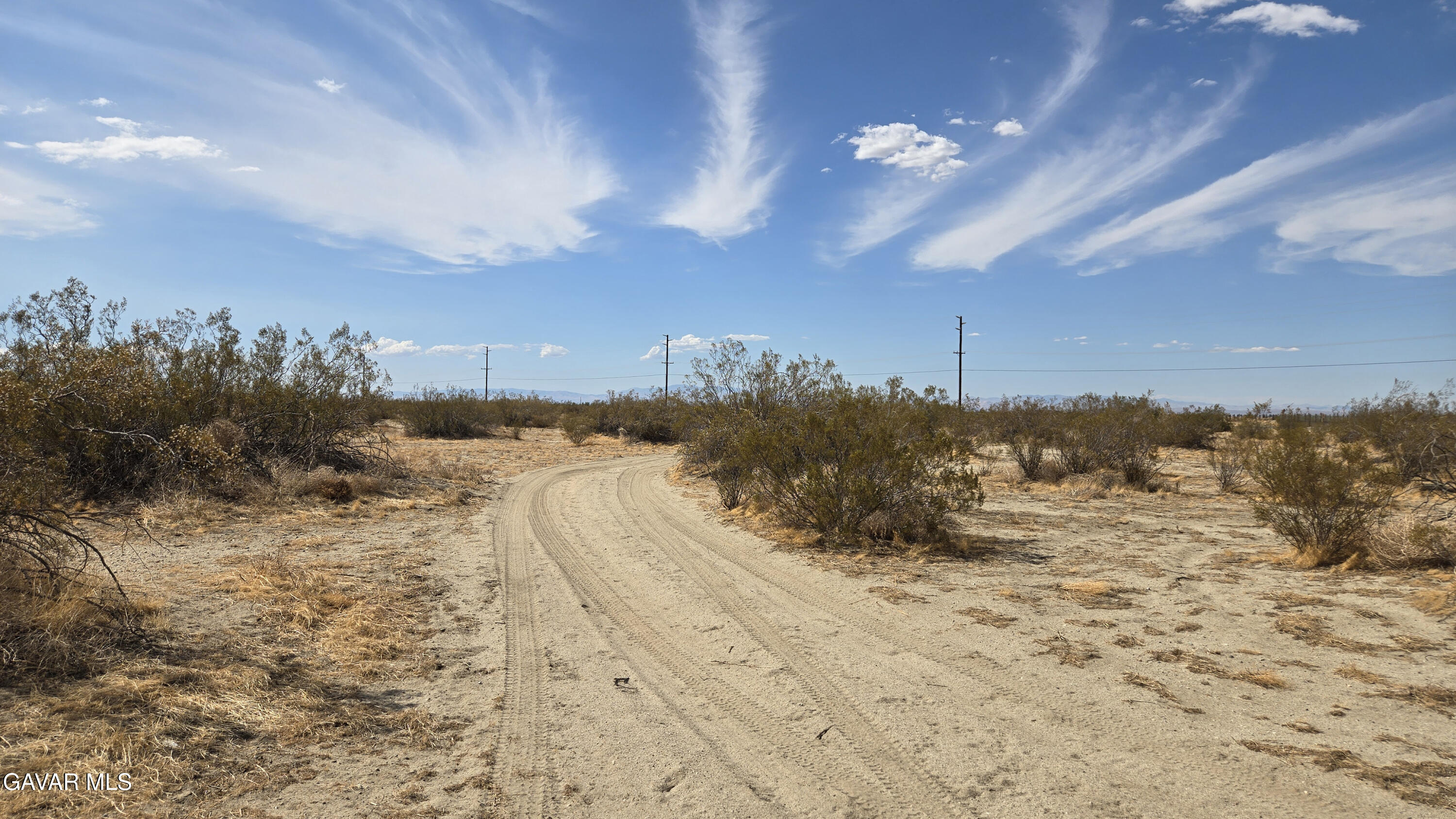 Palmdale Boulevard East Littlerock, CA 93543 - Photo 27 of 34 a view of a dry yard covered with snow in the background