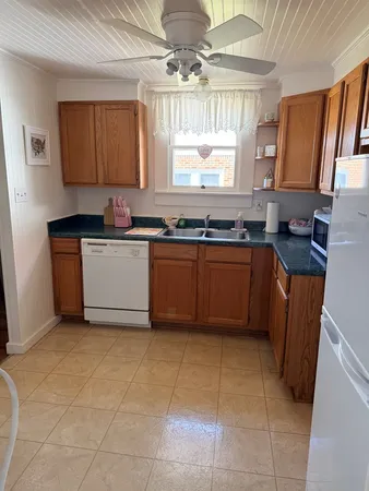 a kitchen with stainless steel appliances granite countertop a sink counter space cabinets and a window