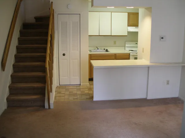 a view of a kitchen with cabinets and a sink