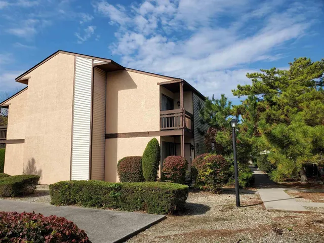 a tall building with trees in front of it