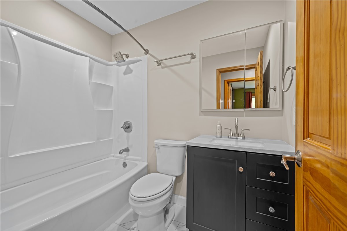 124 Heathgate Road Montgomery, IL 60538 - Photo 23 of 28 a bathroom with a granite countertop sink toilet and shower