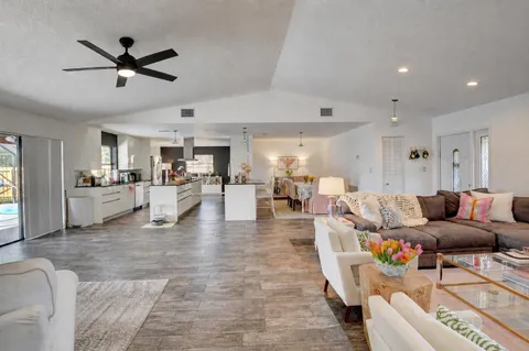 a living room with furniture and kitchen view