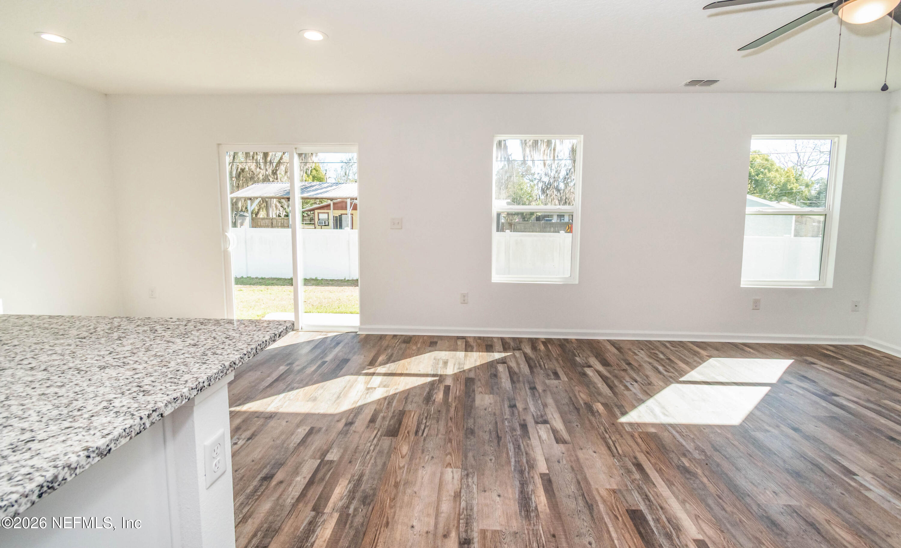 768 Constitution Place Macclenny, FL 32063 - Photo 11 of 41 an empty room with wooden floor and window