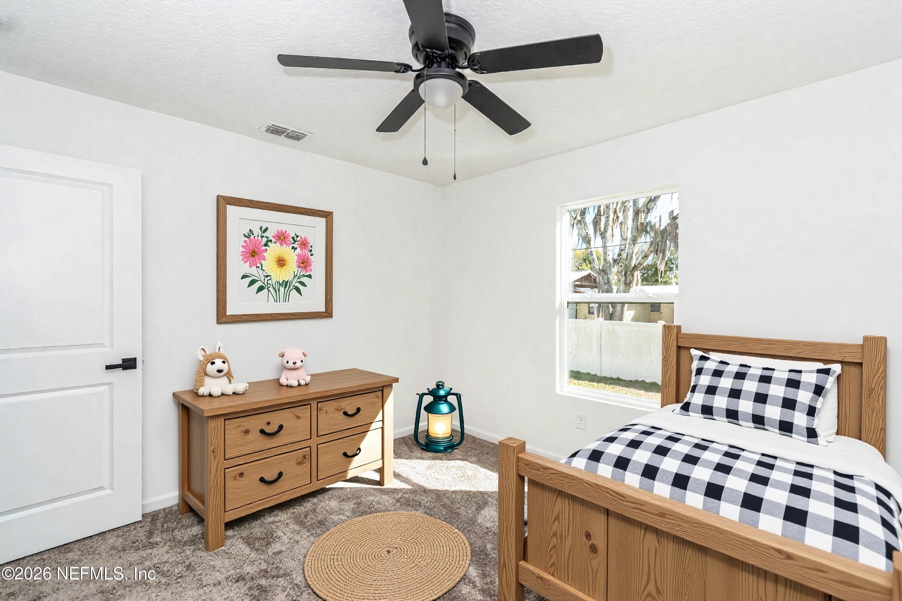 768 Constitution Place Macclenny, FL 32063 - Photo 18 of 41 a bedroom with a bed dresser and a window