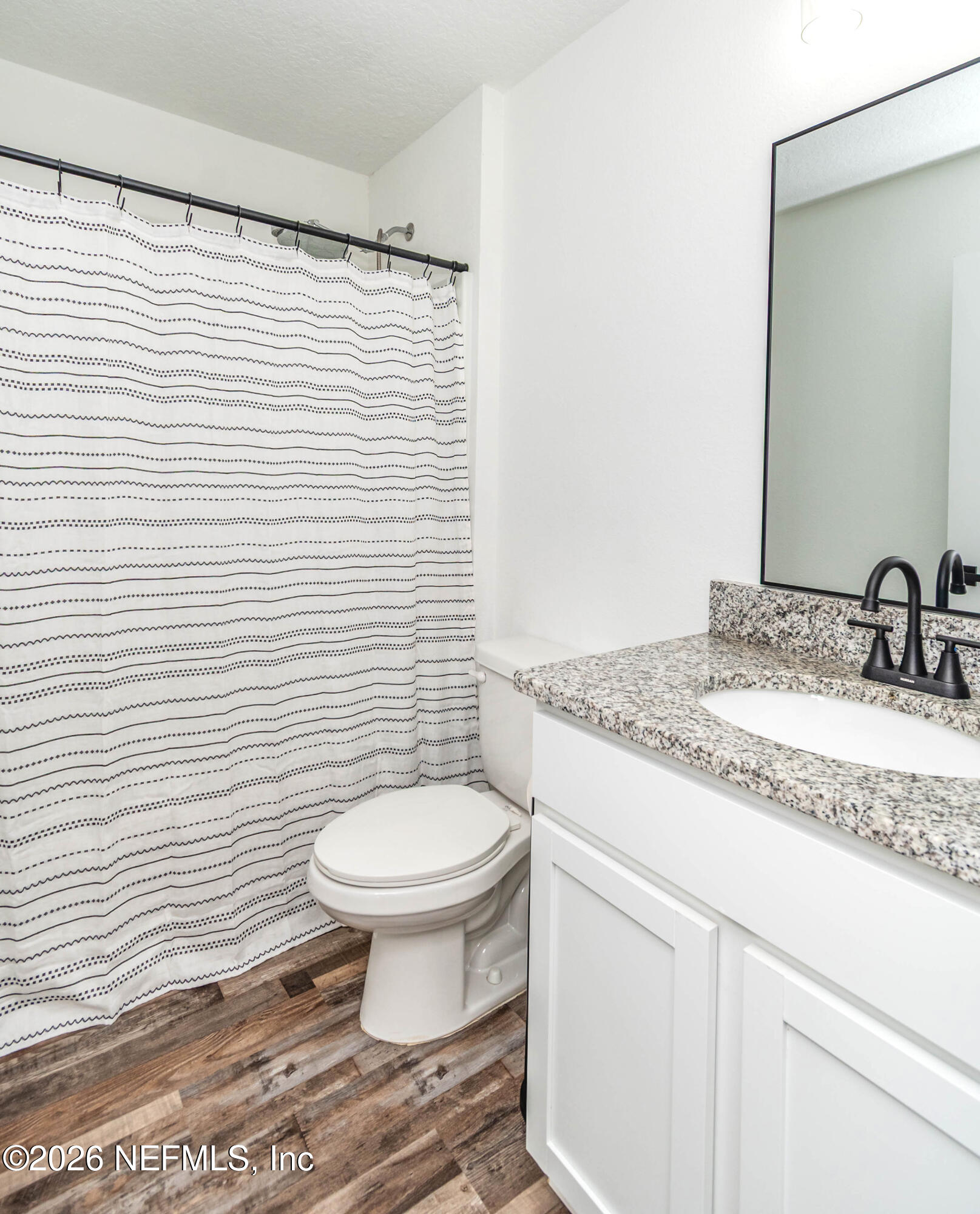 768 Constitution Place Macclenny, FL 32063 - Photo 20 of 41 a bathroom with a sink toilet and a mirror