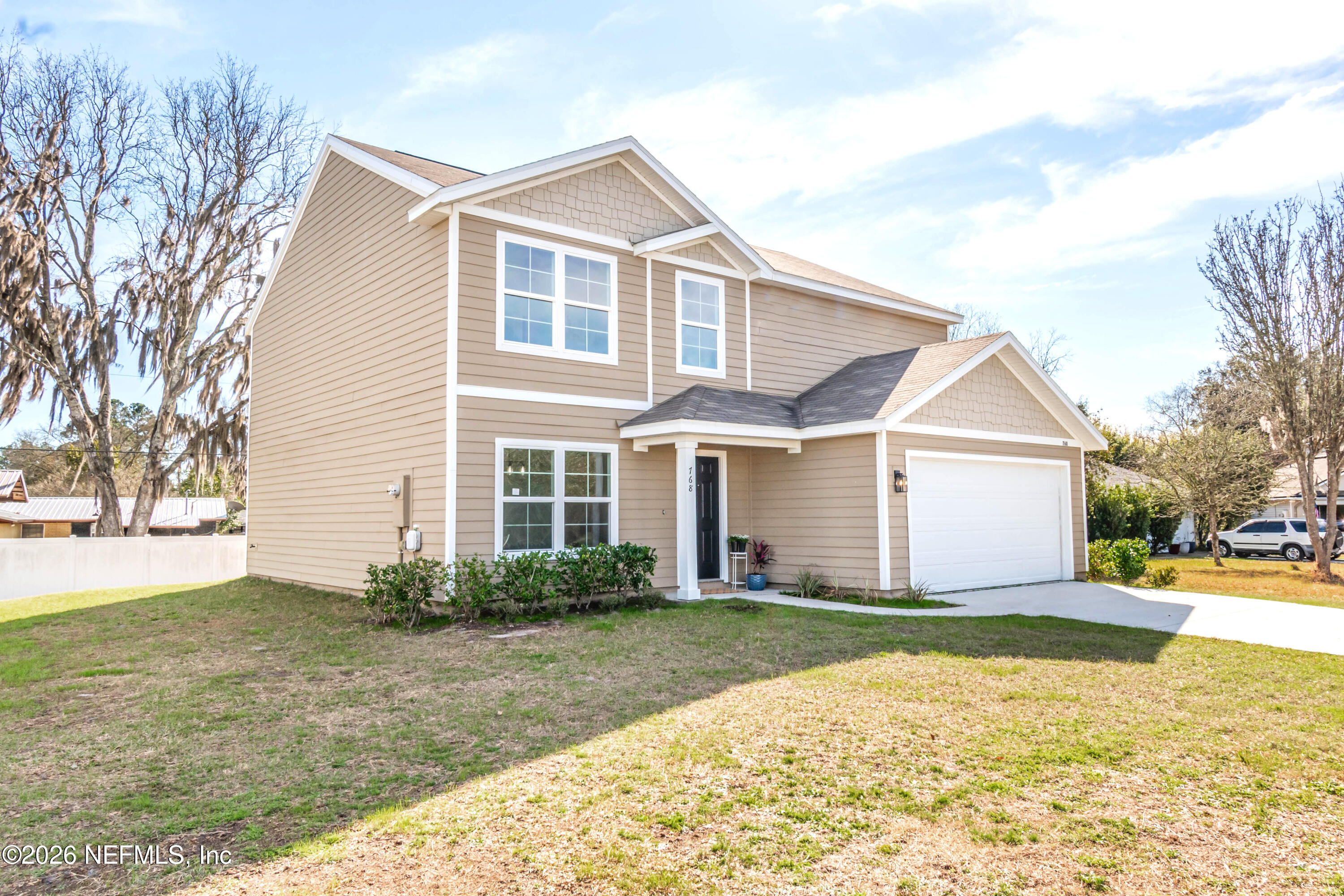 768 Constitution Place Macclenny, FL 32063 - Photo 2 of 41 a front view of a house with a yard and trees