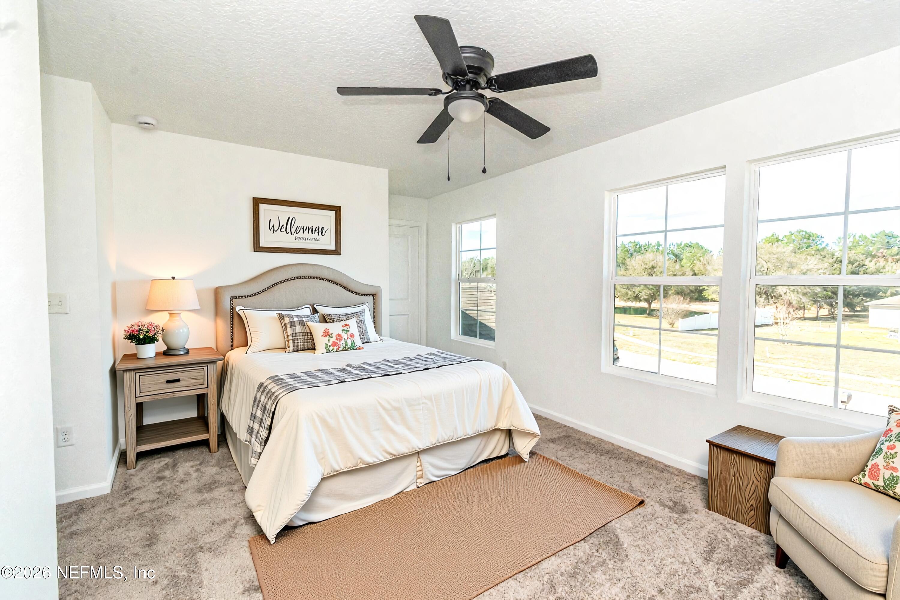 768 Constitution Place Macclenny, FL 32063 - Photo 26 of 41 a bedroom with a bed and a couch