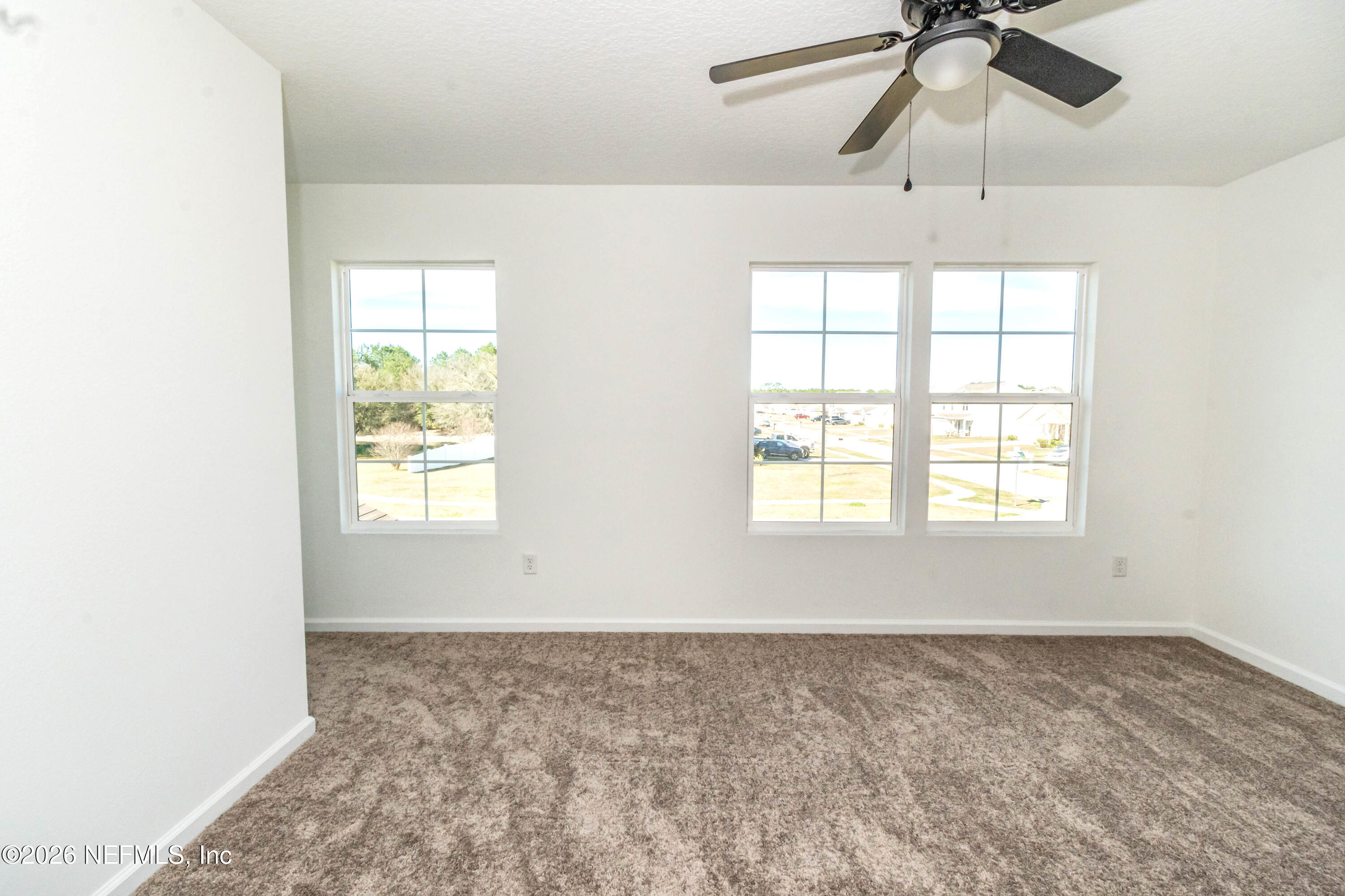 768 Constitution Place Macclenny, FL 32063 - Photo 27 of 41 an empty room with a window and a ceiling fan
