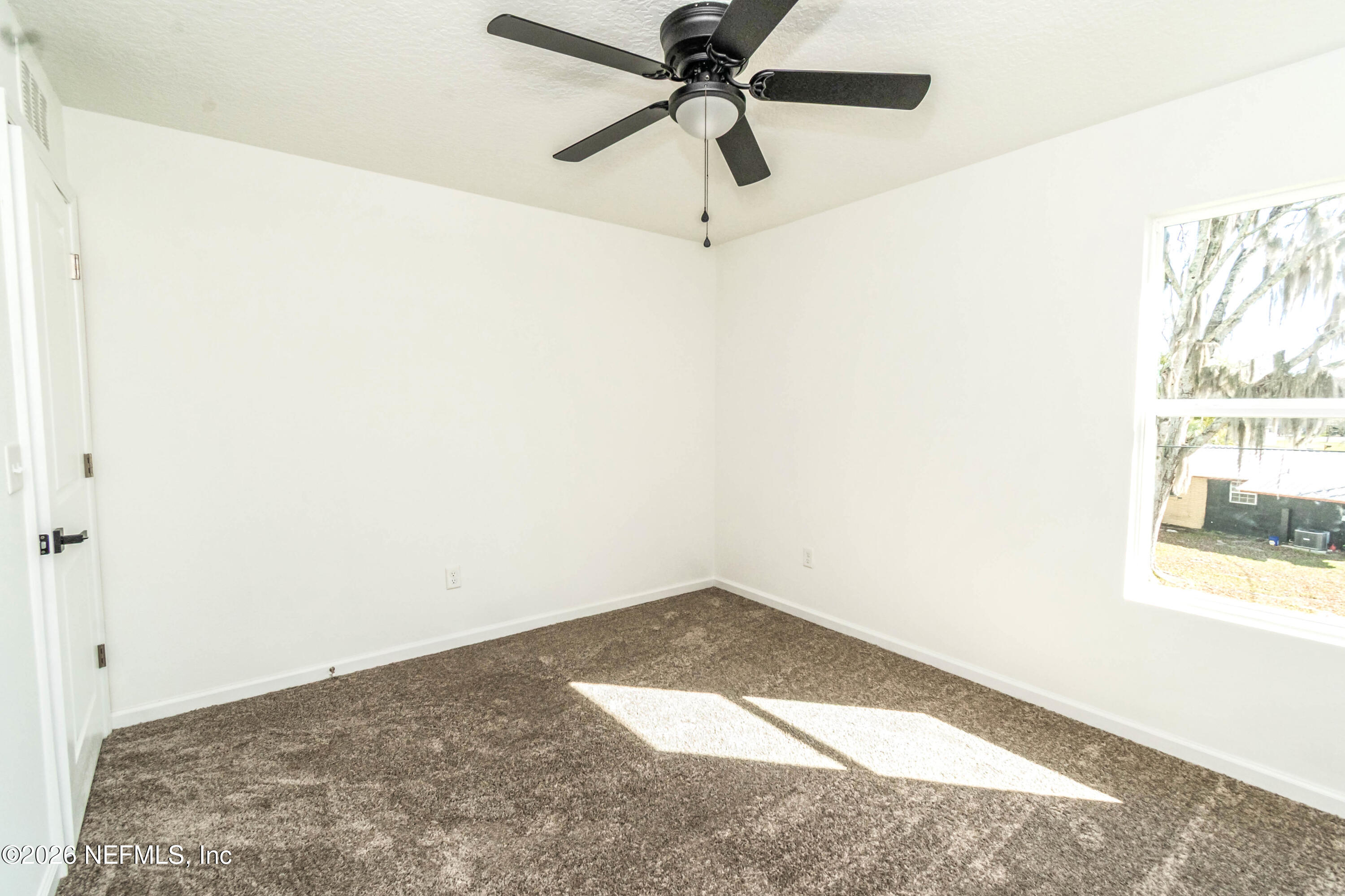 768 Constitution Place Macclenny, FL 32063 - Photo 29 of 41 an empty room with a window and a fan
