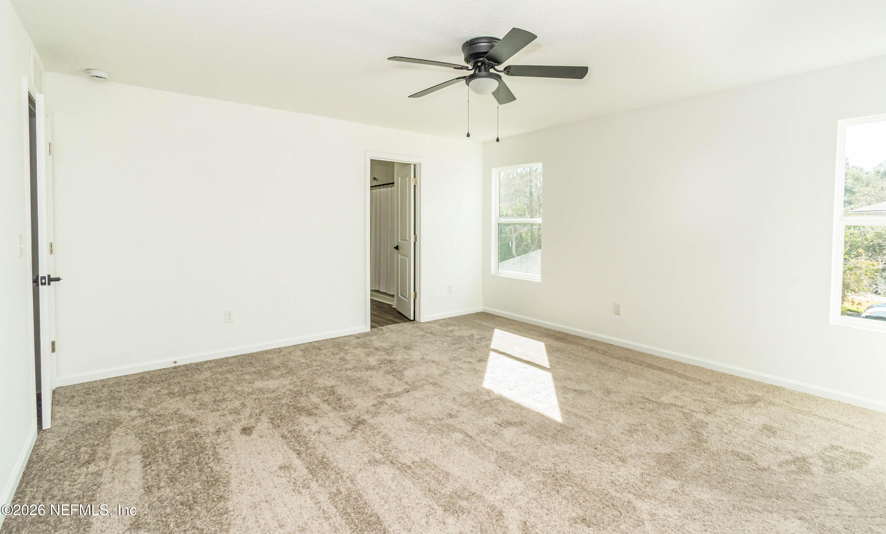 768 Constitution Place Macclenny, FL 32063 - Photo 32 of 41 a view of a big room with wooden floor and a chandelier fan