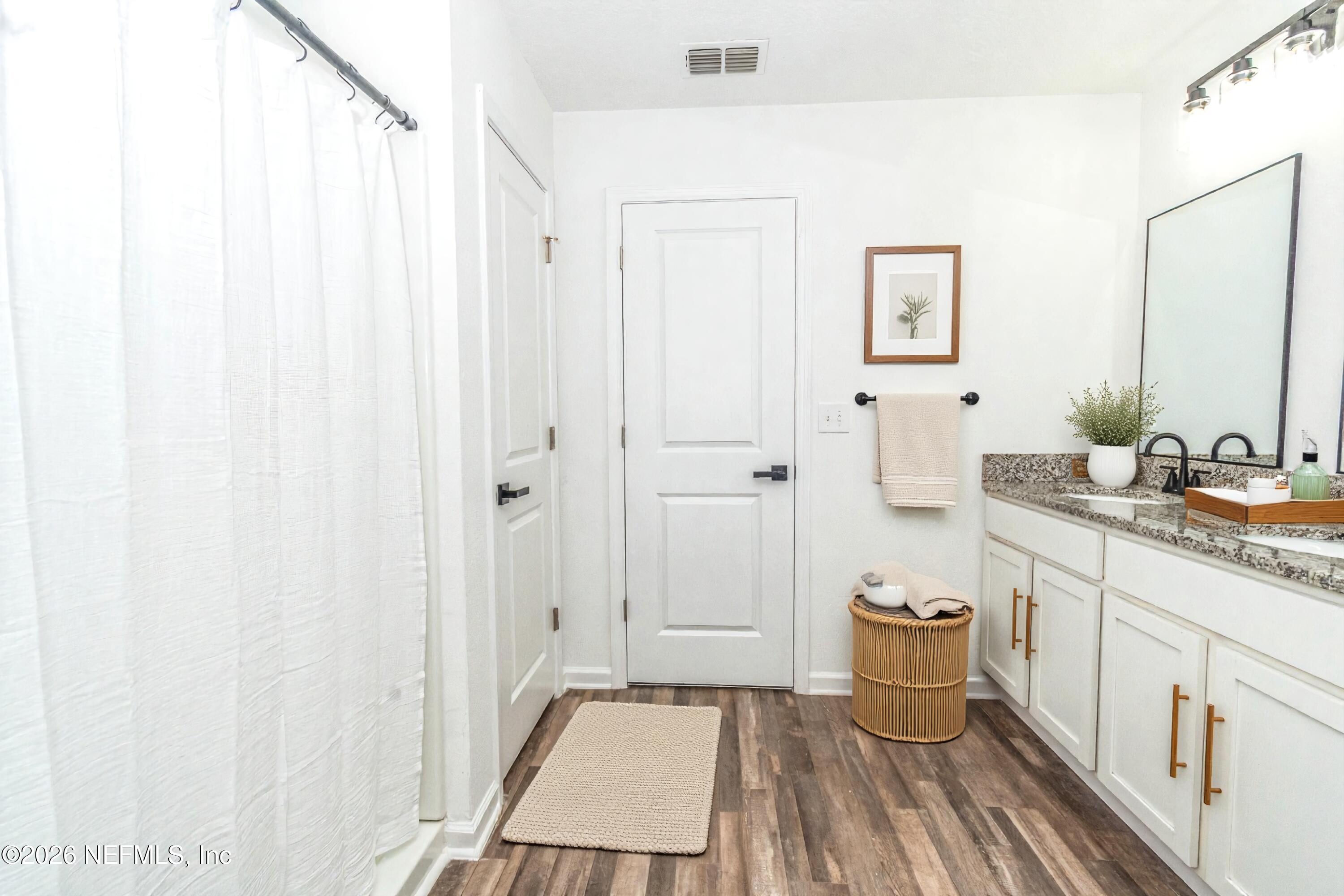 768 Constitution Place Macclenny, FL 32063 - Photo 36 of 41 a spacious bathroom with a granite countertop sink a mirror and a shower