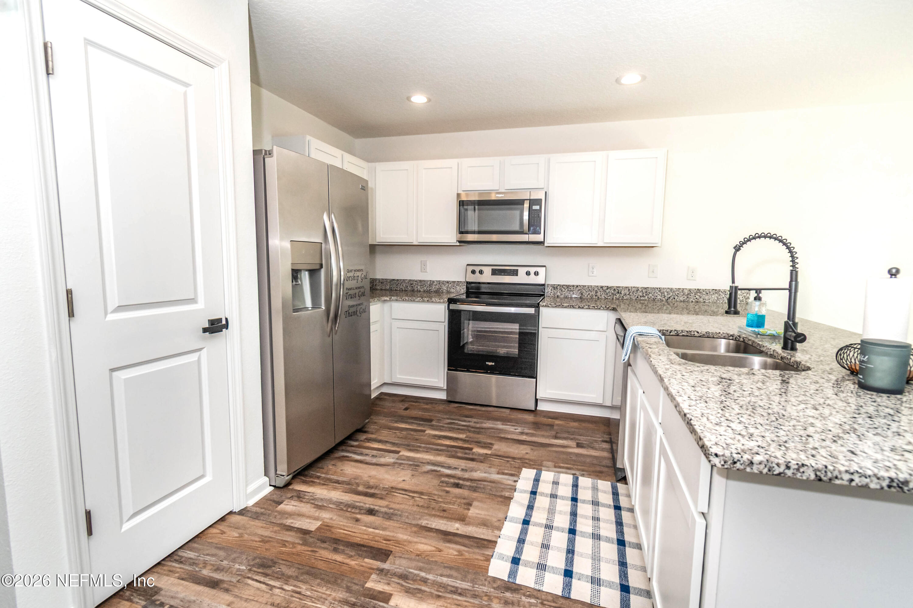 768 Constitution Place Macclenny, FL 32063 - Photo 7 of 41 a kitchen with stainless steel appliances granite countertop a stove top oven a sink and dishwasher