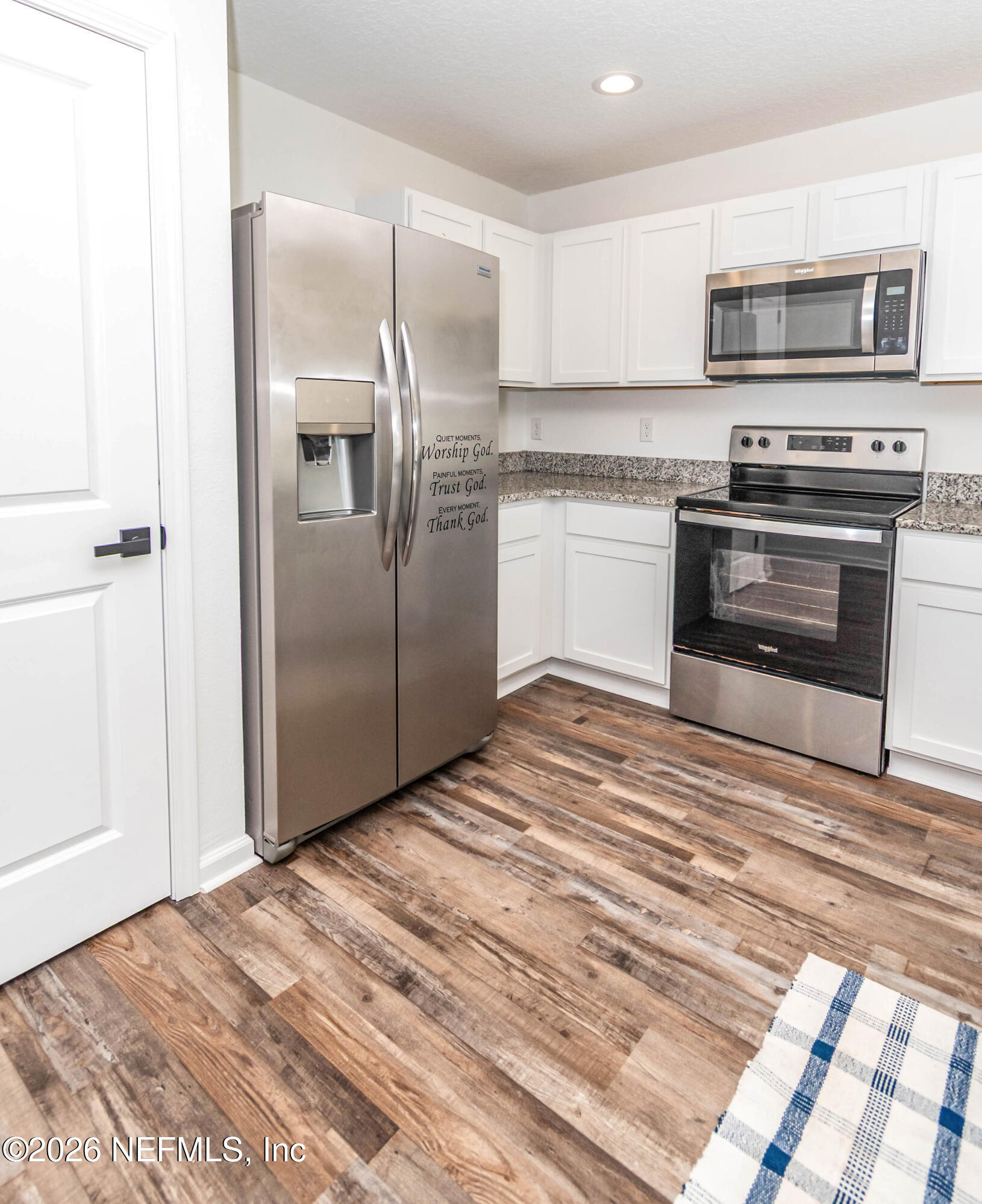 768 Constitution Place Macclenny, FL 32063 - Photo 9 of 41 a kitchen with kitchen island a stove and a refrigerator